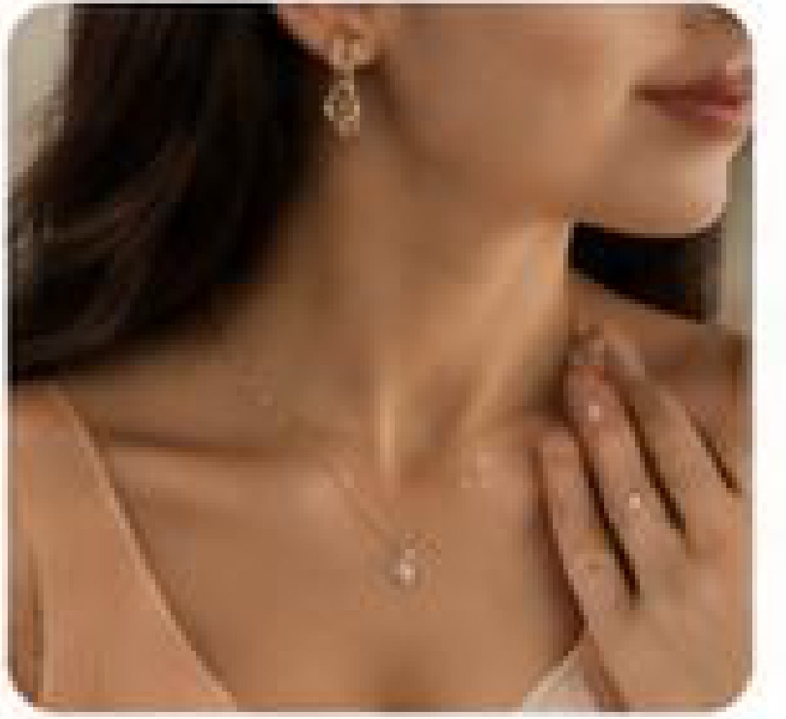 A customer wearing a pendant and drop earrings